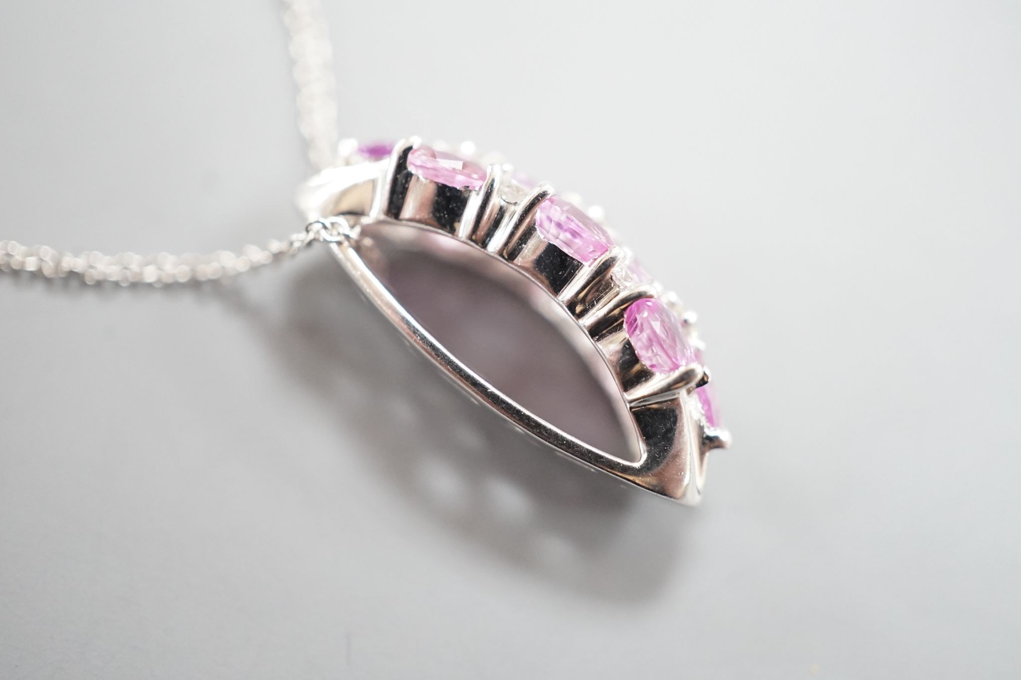 A modern 14k white metal pink sapphire and diamond cluster set pendant, on a 14k fine link chain(knotted)